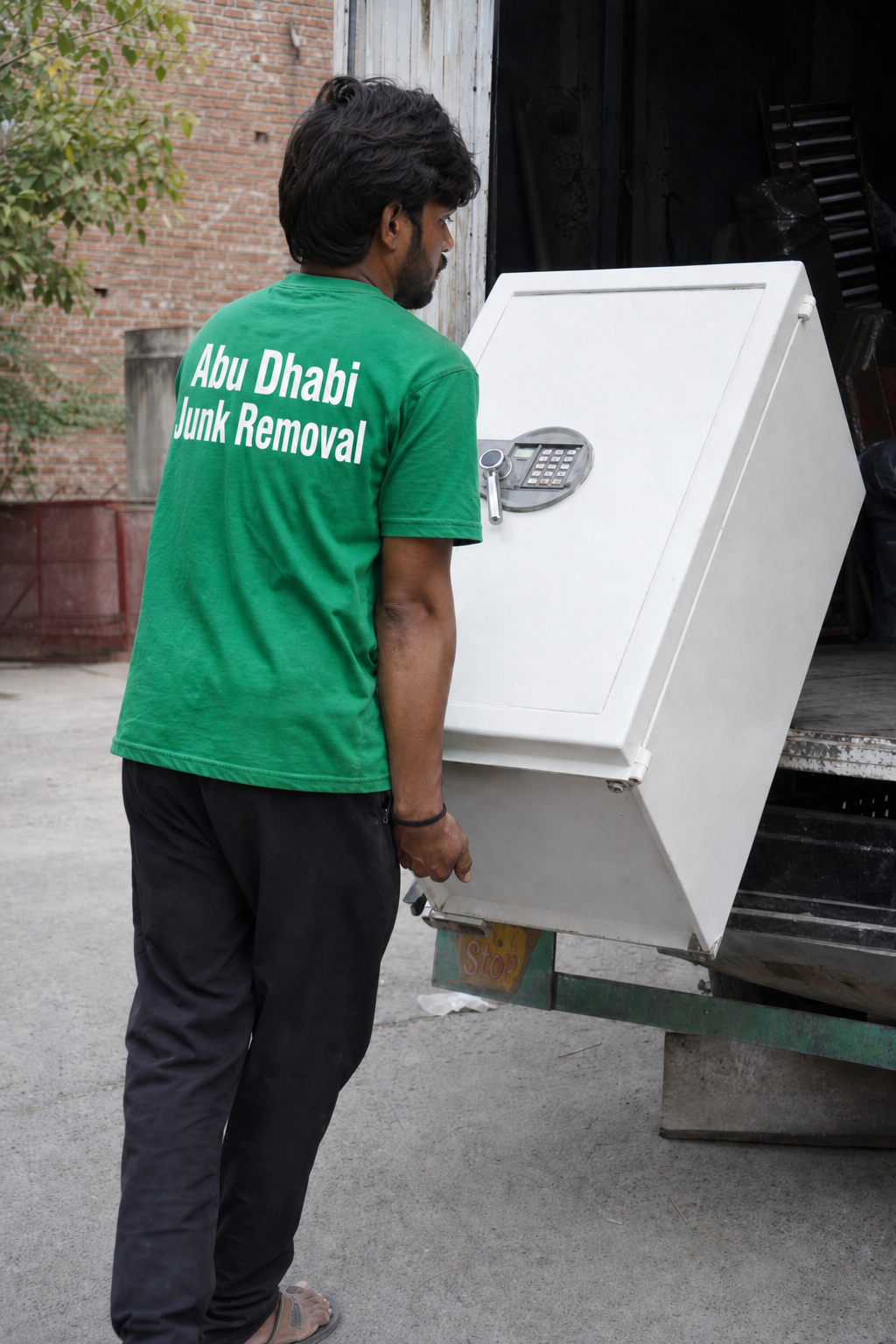 Team moving bulky items into a truck